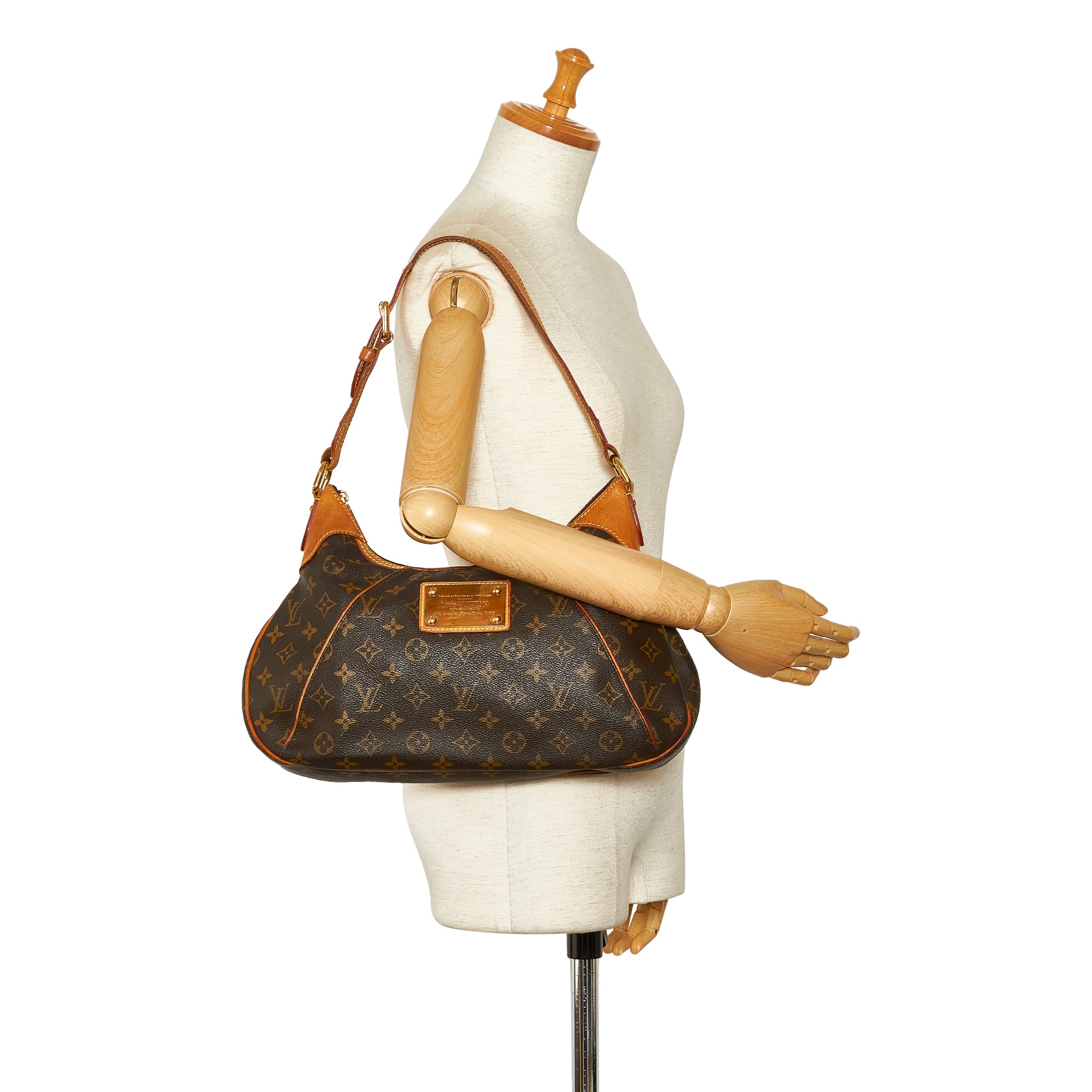 LOUIS VUITTON. Brown monogram canvas and leather report…