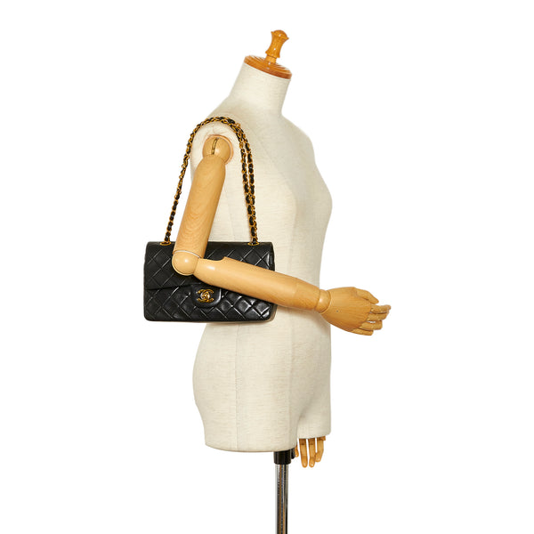 Chanel, Vintage mini black lambskin quilted handbag with gold hardware. -  Unique Designer Pieces